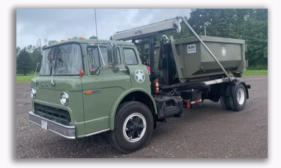 truck with a roll off container loaded